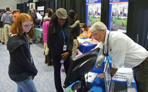 Mike Robinson demonstrates GIS to two attendees. 